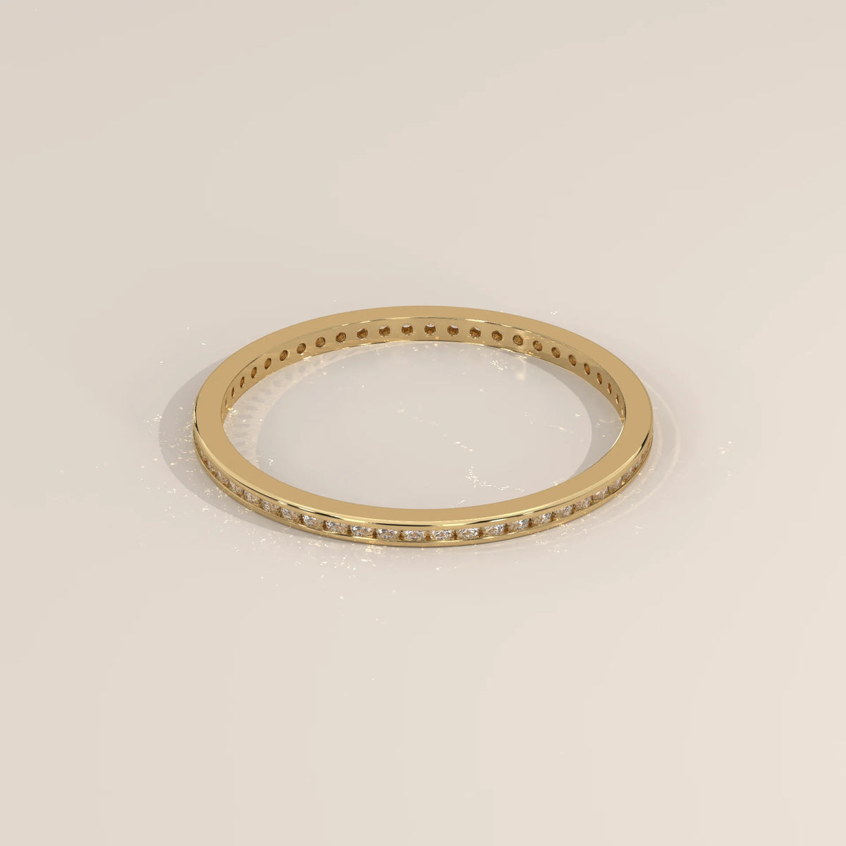 Yellow gold eternity ring with round lab grown diamonds channel set flush in a flat band, viewed from overhead.