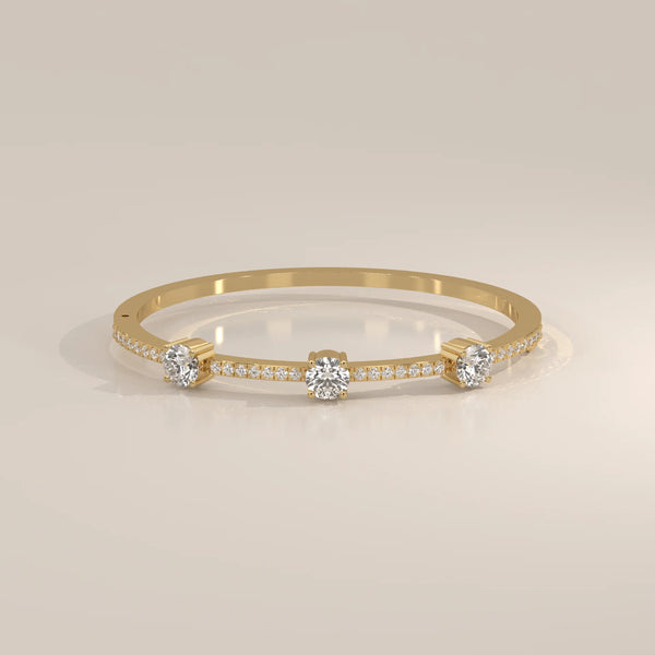 A delicate 18k gold bangle bracelet adorned with diamonds.