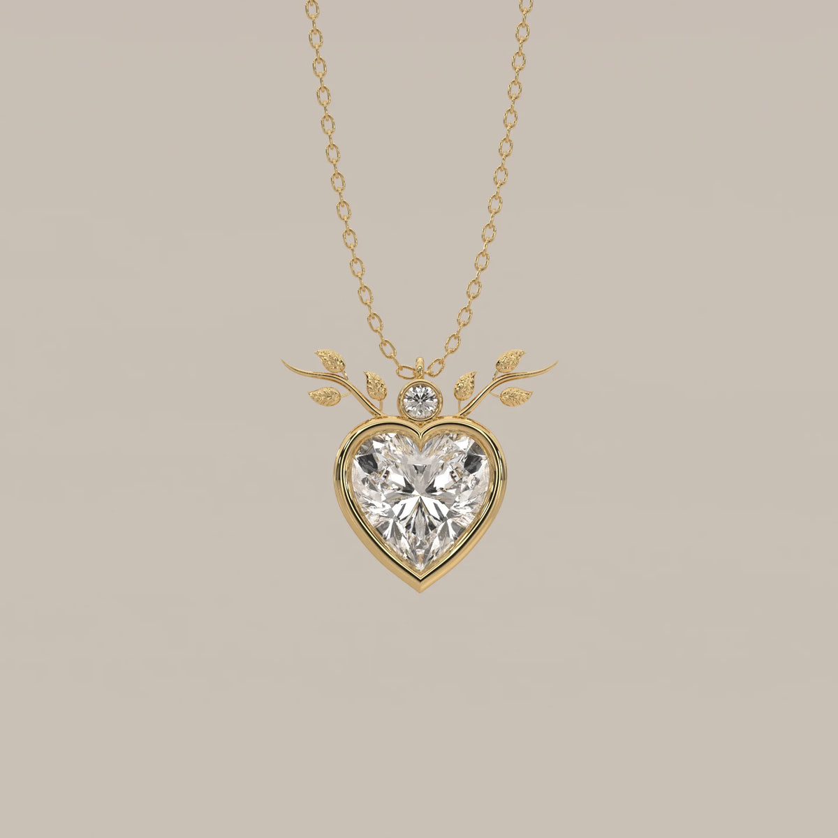 Bezel Heart Lab Grown Diamond Pendant with Leafy Branch Crown in yellow gold, shown from the front.