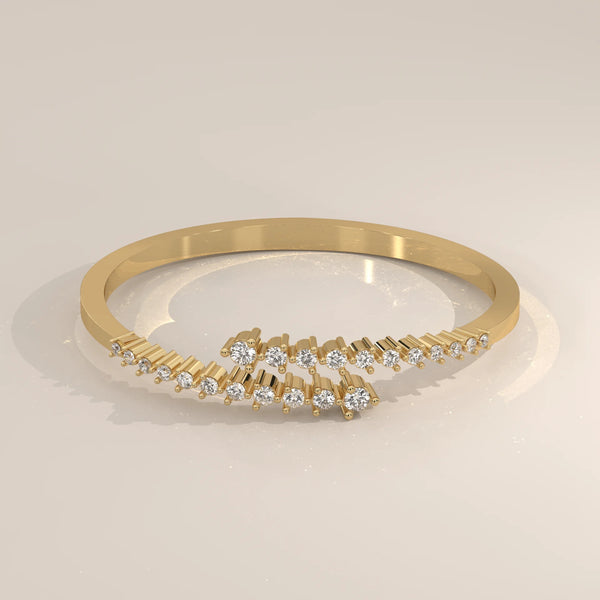 A delicate gold bracelet with scattered diamonds arranged in a wave pattern.