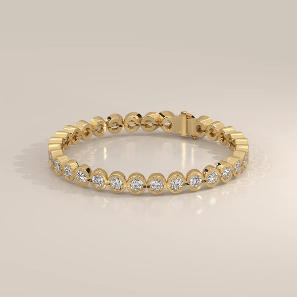 A classic 14k gold bracelet with bezel-set round diamonds.