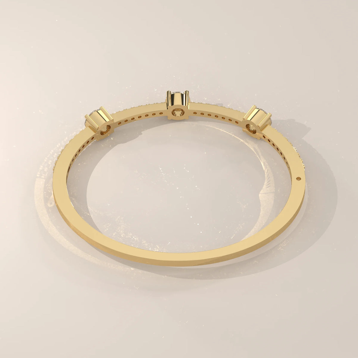 Delicate yellow gold bracelet with three round cut diamonds and pave side stones.