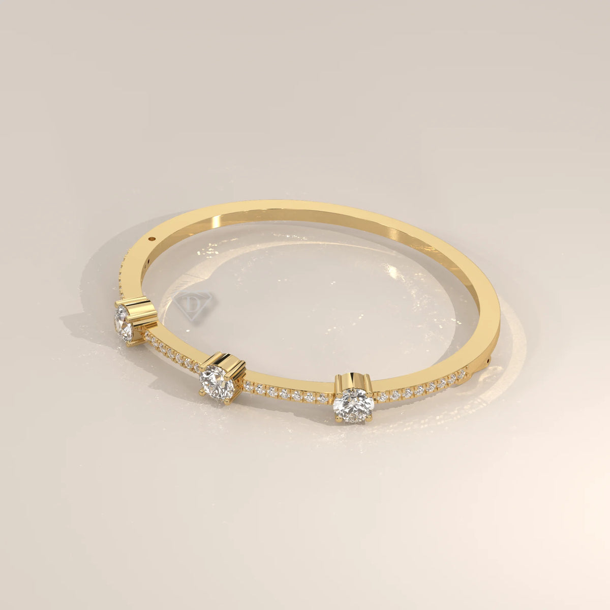 Yellow gold bangle bracelet with three round diamonds and small accent stones.