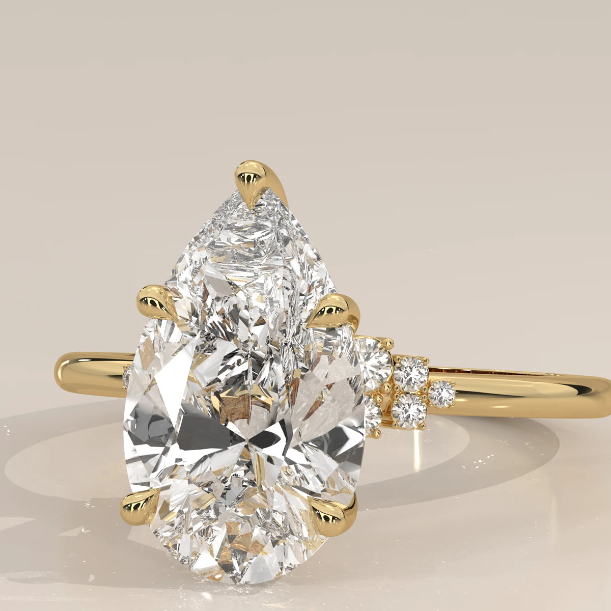 Bronze 5 Carat Pear Lab Grown Diamond Ring, Cluster Shoulders in yellow gold, photographed from the side.