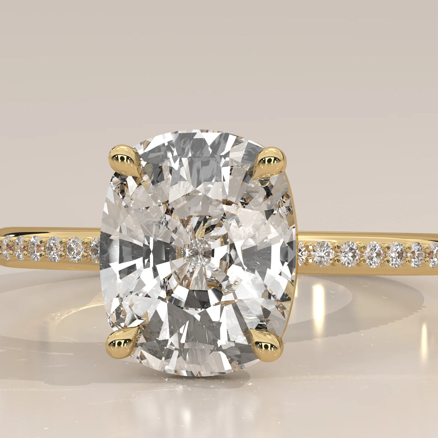 A close-up view of a cushion-cut diamond engagement ring in 14k yellow gold.