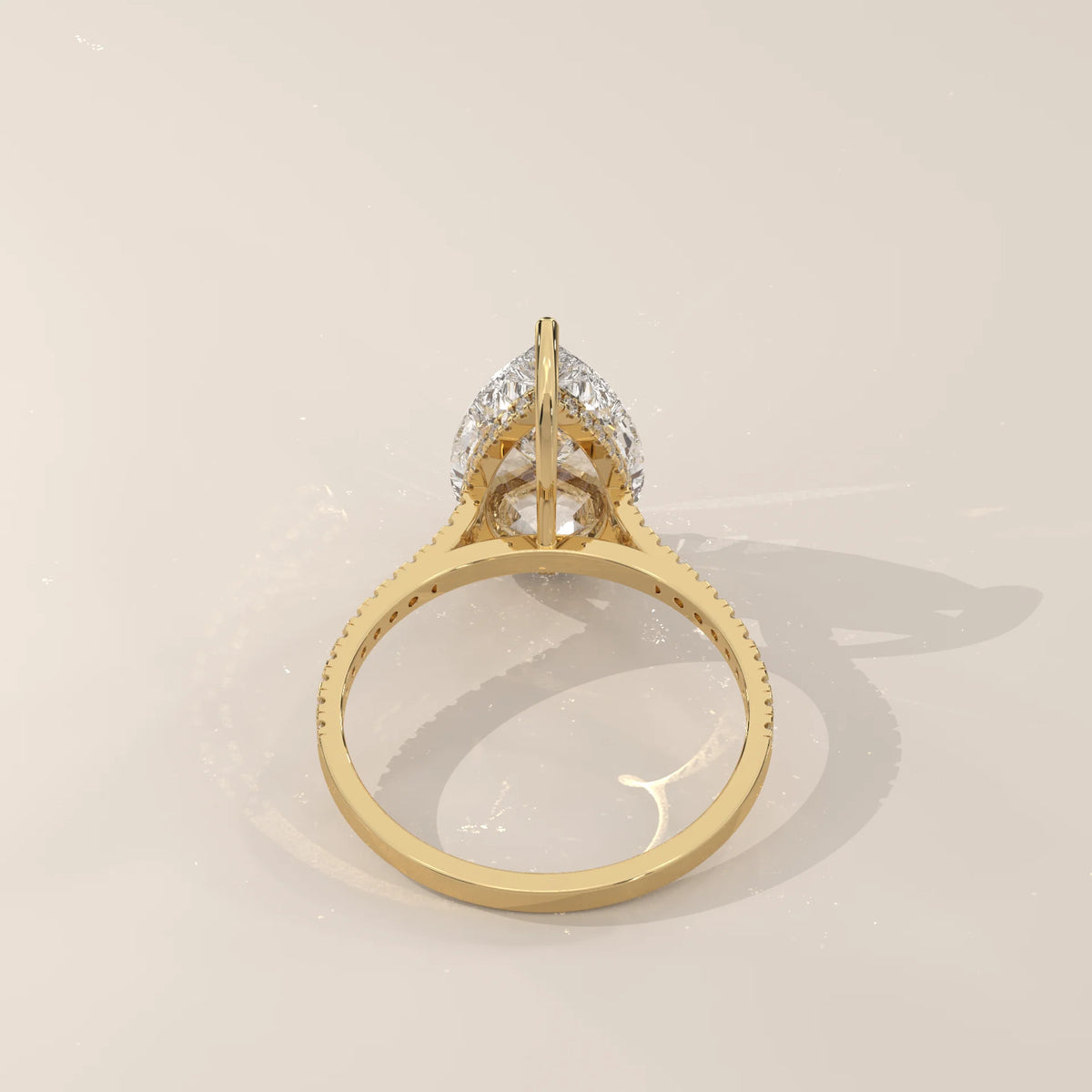 Cygri 5 Carat Pear Lab Grown Diamond Ring, Hidden Halo Pave Band in yellow gold, side profile view.
