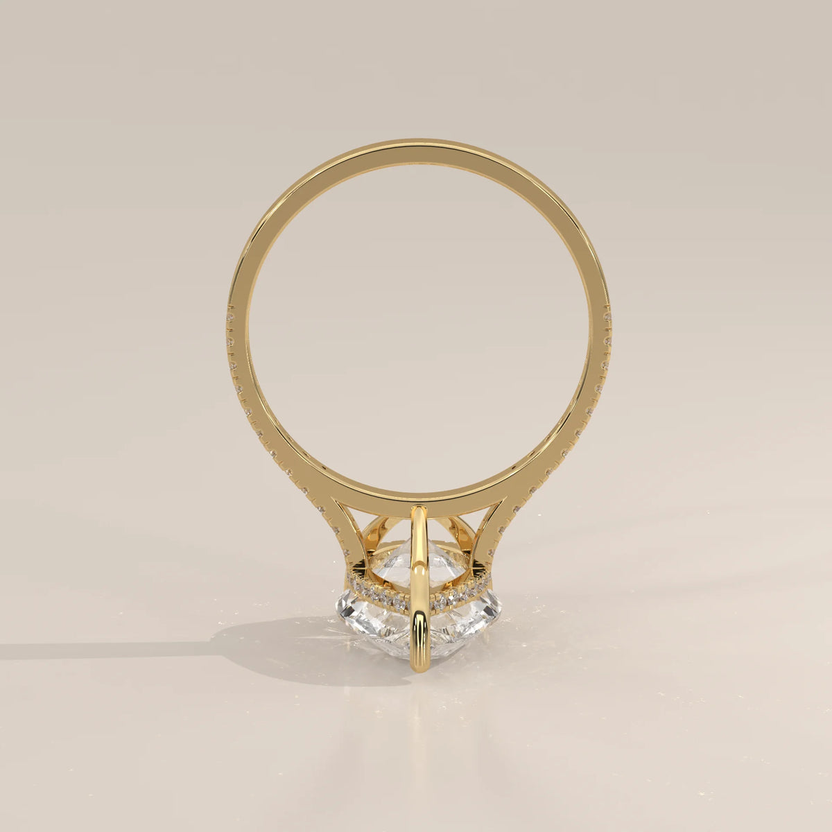 Cygri 5 Carat Pear Lab Grown Diamond Ring, Hidden Halo Pave Band in yellow gold, photographed from the side.