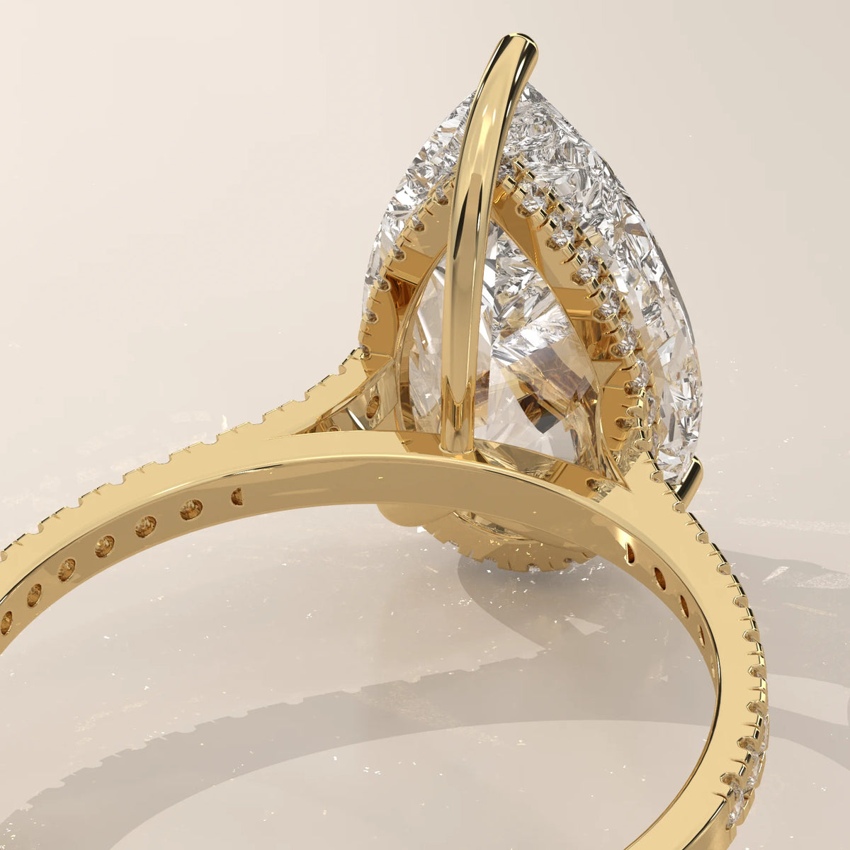 Cygri 5 Carat Pear Lab Grown Diamond Ring, Hidden Halo Pave Band in yellow gold, shown on a plain background.