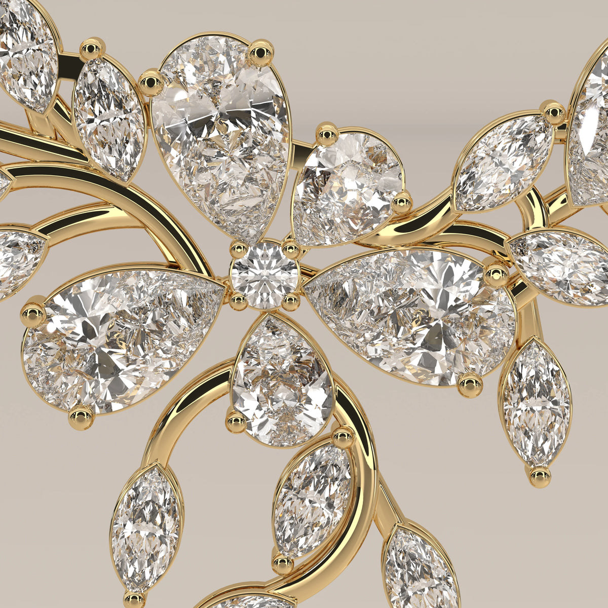 A marquise and pear lab grown diamond leaf necklace in yellow gold, shown in close-up.
