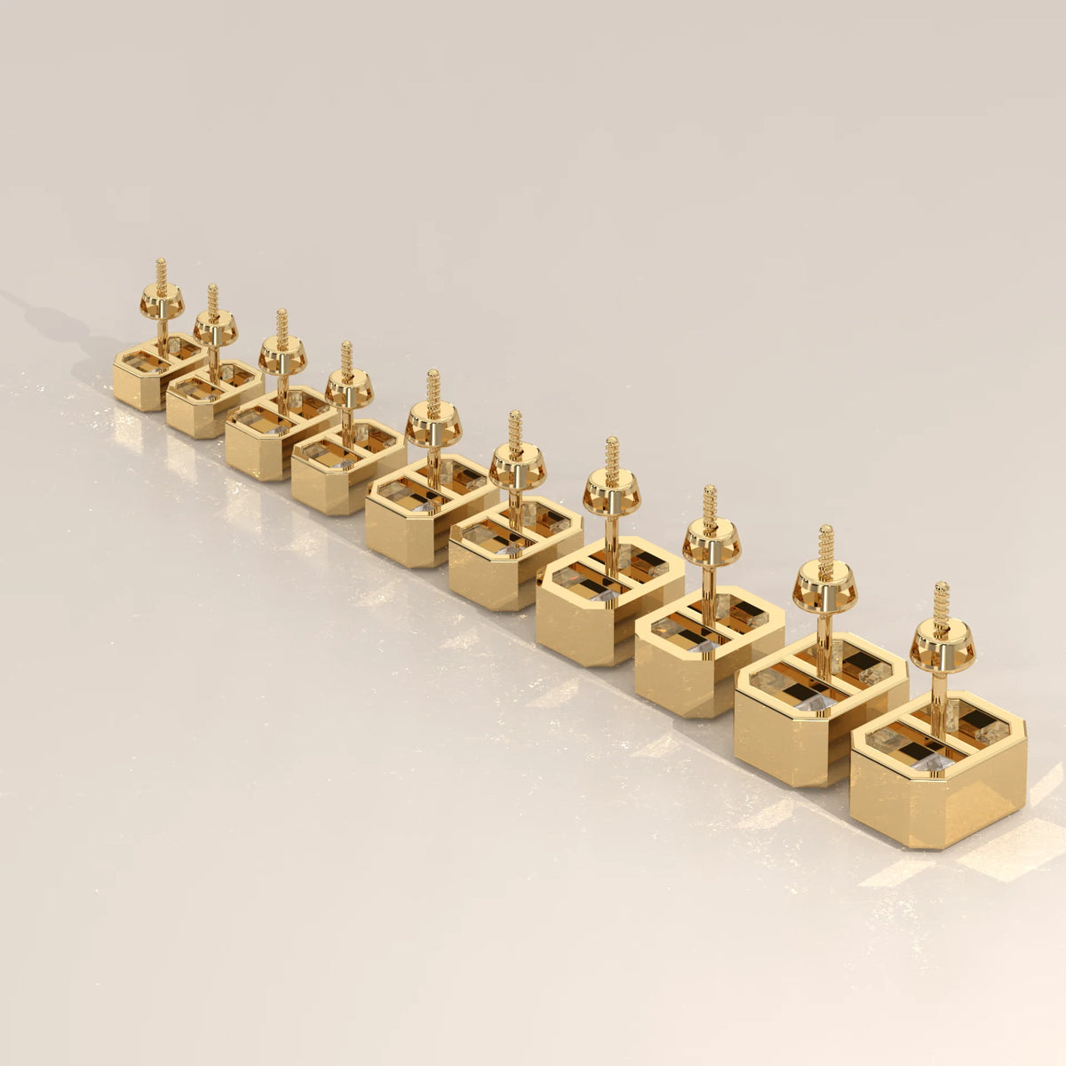 Gold stud earrings with square-cut diamonds, presented at an angle.