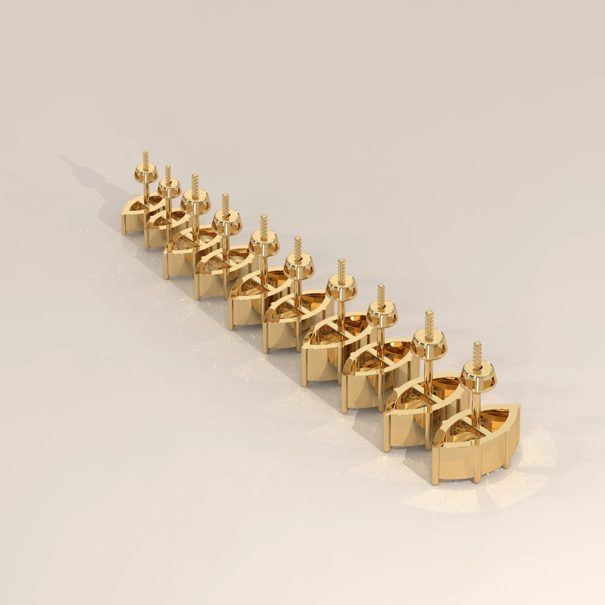 A row of small, golden stud earrings with diamonds arranged diagonally.