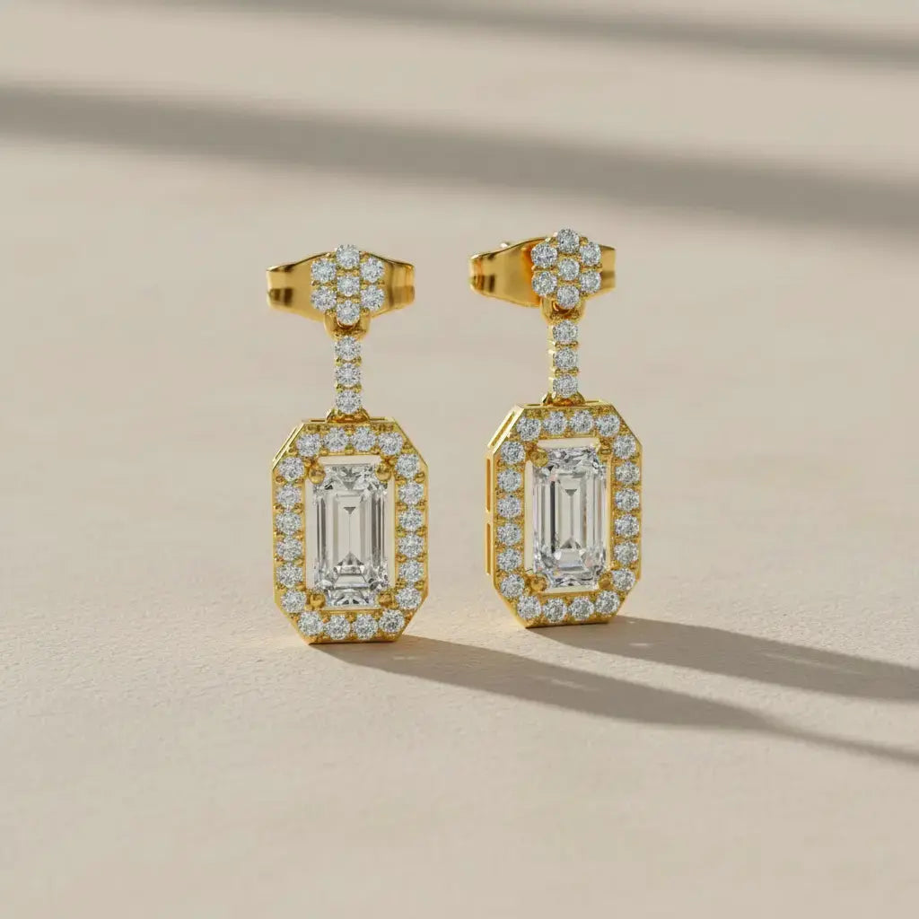 Flat Lay: Emerald Cut Diamond Earrings with Halo Setting in 14k Yellow Gold - Lab Grown - Driona Jewels