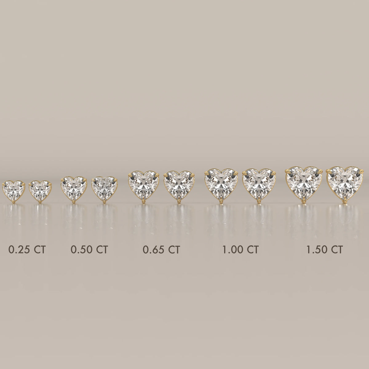 A line of heart-shaped diamond stud earrings in yellow gold.