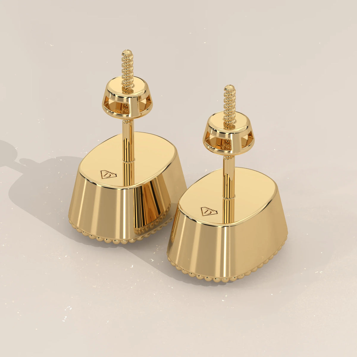 Elongated Cushion Lab Grown Diamond Studs in a Milgrain Bezel in yellow gold, angled view on a plain background.