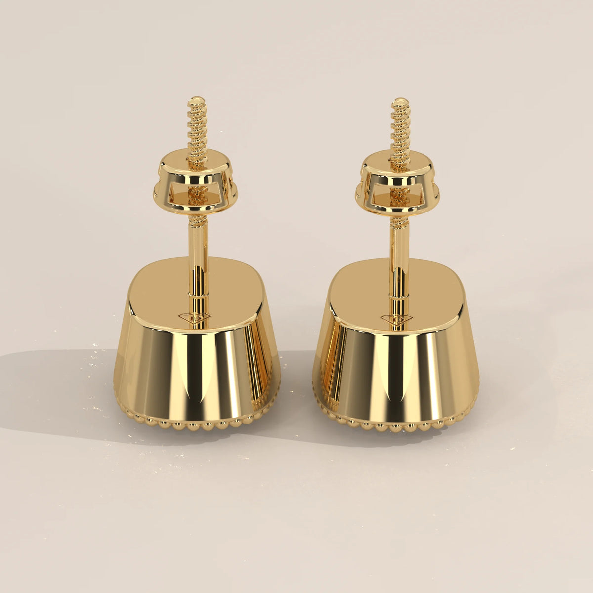 Elongated Cushion Lab Grown Diamond Studs in a Milgrain Bezel in yellow gold, photographed head-on.