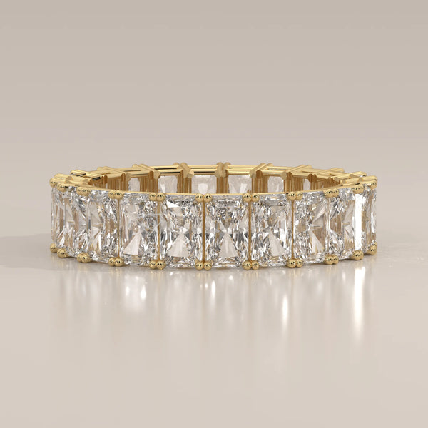 Elongated Radiant Cut Diamond Eternity Band Set East West in yellow gold, shown from the front.