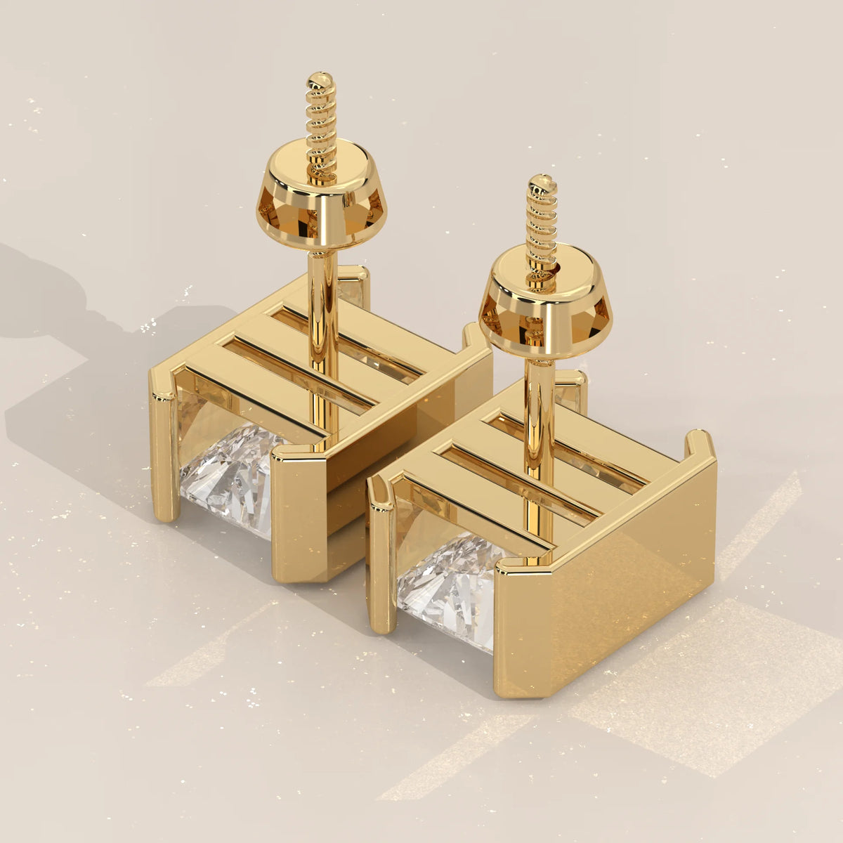 Elongated Radiant Half Bezel Lab Grown Diamond Stud Earrings in yellow gold, product photograph on a plain background.