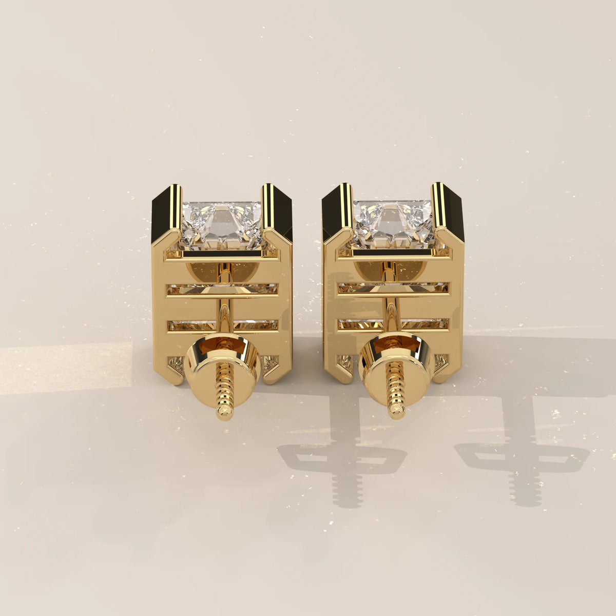 Elongated Radiant Half Bezel Lab Grown Diamond Stud Earrings in yellow gold, photographed head-on.