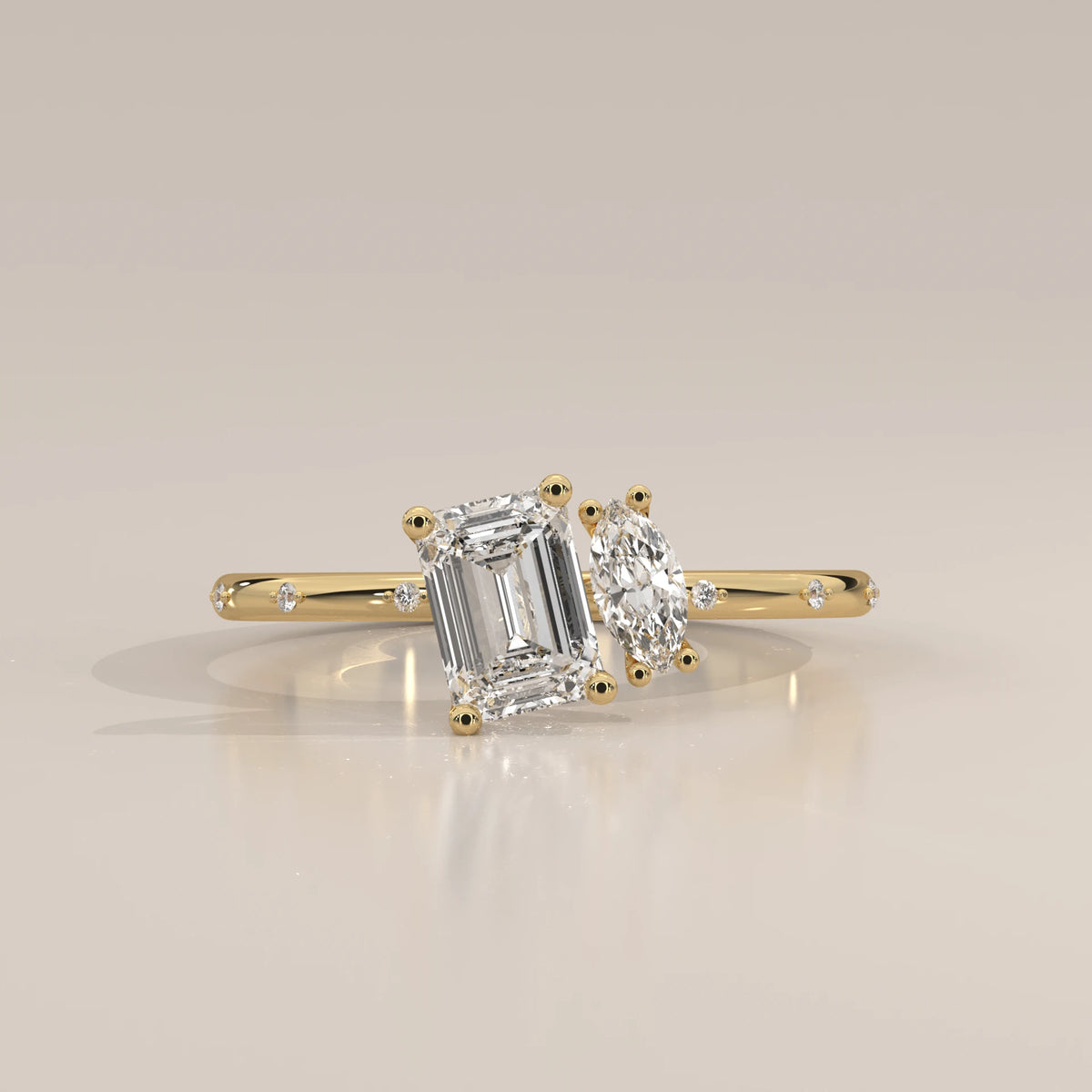 Yellow gold ring with an emerald-cut and a marquise-cut diamond.