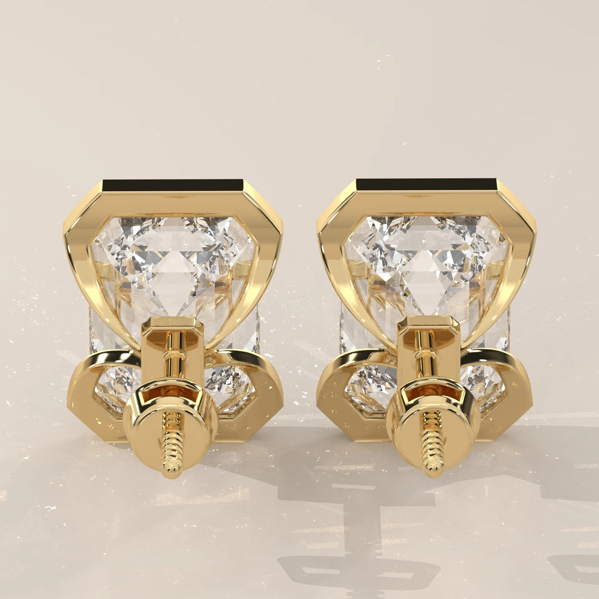Emerald Cut Partial Bezel Lab Grown Diamond Stud Earrings in yellow gold, shown at an angle.