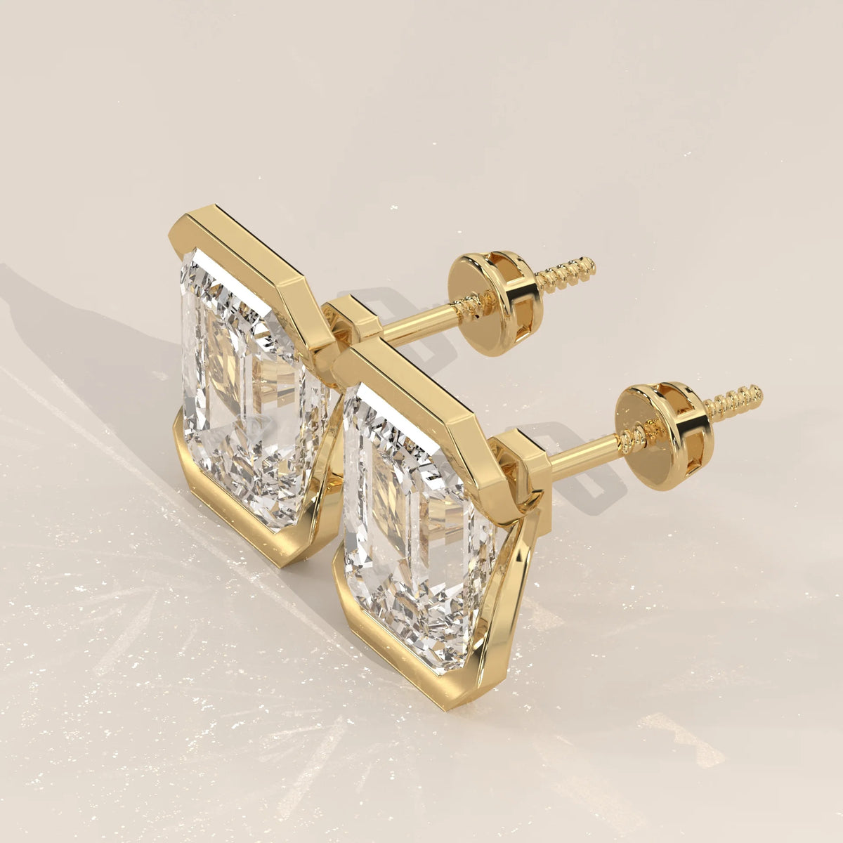 Emerald Cut Partial Bezel Lab Grown Diamond Stud Earrings in yellow gold, shown from the side.