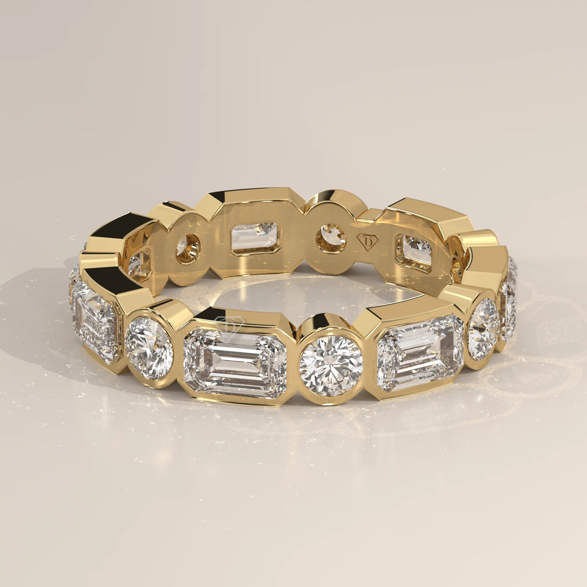 Emerald and Round Lab Grown Diamond Bezel Set Eternity Band in yellow gold, photographed head-on.