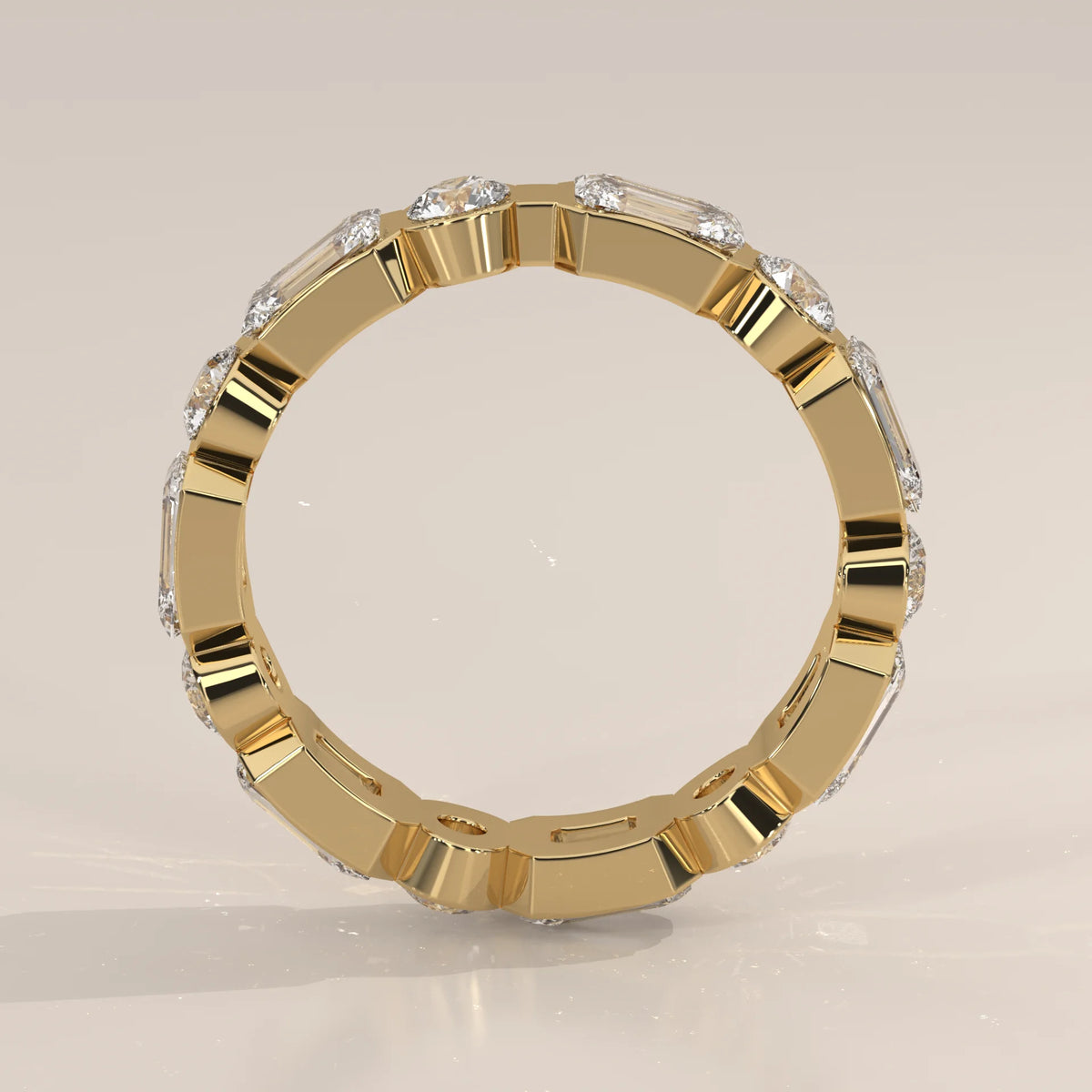 Emerald and Round Lab Grown Diamond Bezel Set Eternity Band in yellow gold, shown from the side.