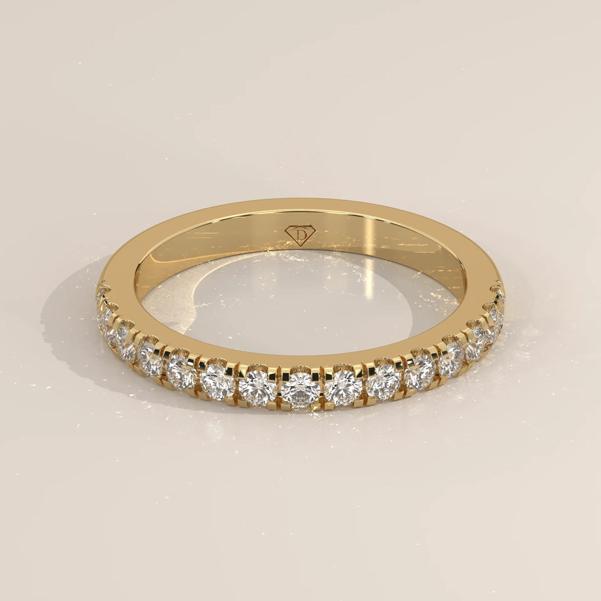 Yellow gold band with larger claw set round lab grown diamonds in a raised pave row, shown from the front.