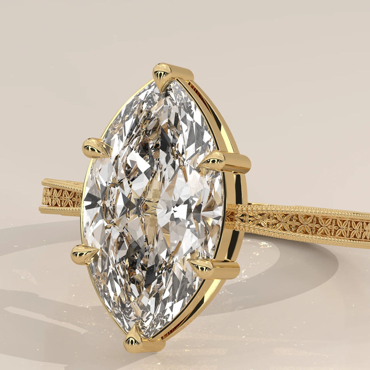 Ginnie 5 Carat Marquise Lab Grown Diamond Ring, Engraved Floral Band in yellow gold, shown on a plain background.