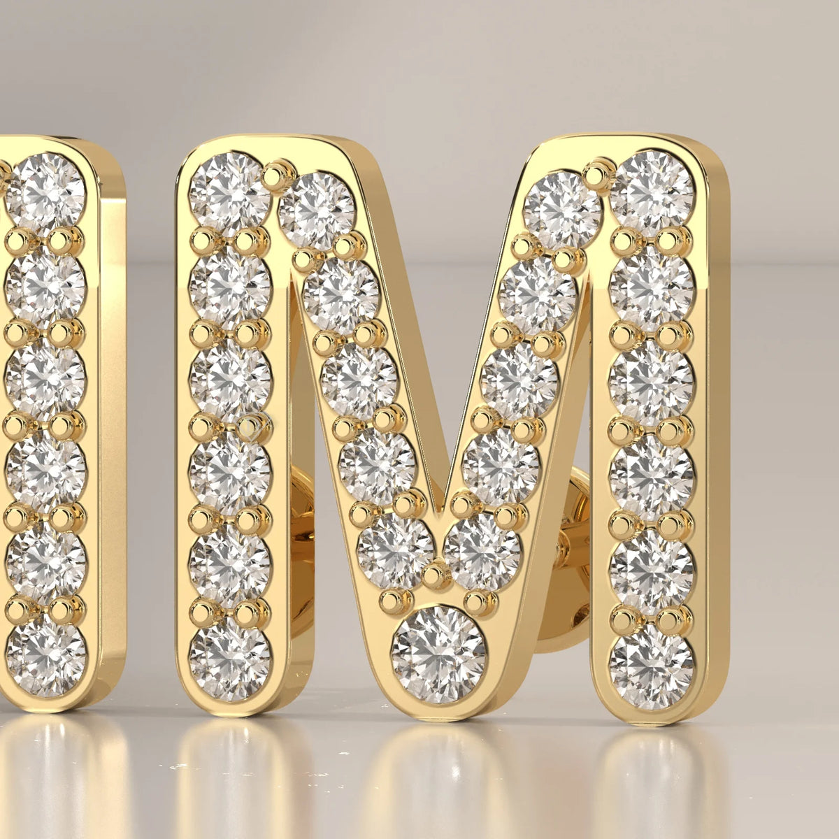 Letter M Initial Pave Lab Grown Diamond Stud Earrings in yellow gold, front view on a plain background.