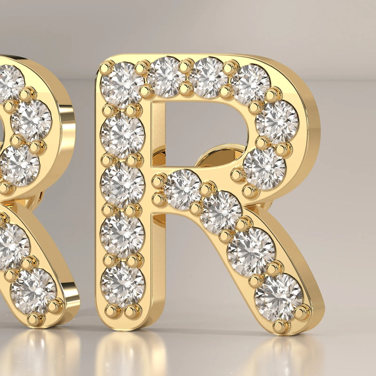 Letter R Initial Pave Lab Grown Diamond Stud Earrings in yellow gold, front view on a plain background.
