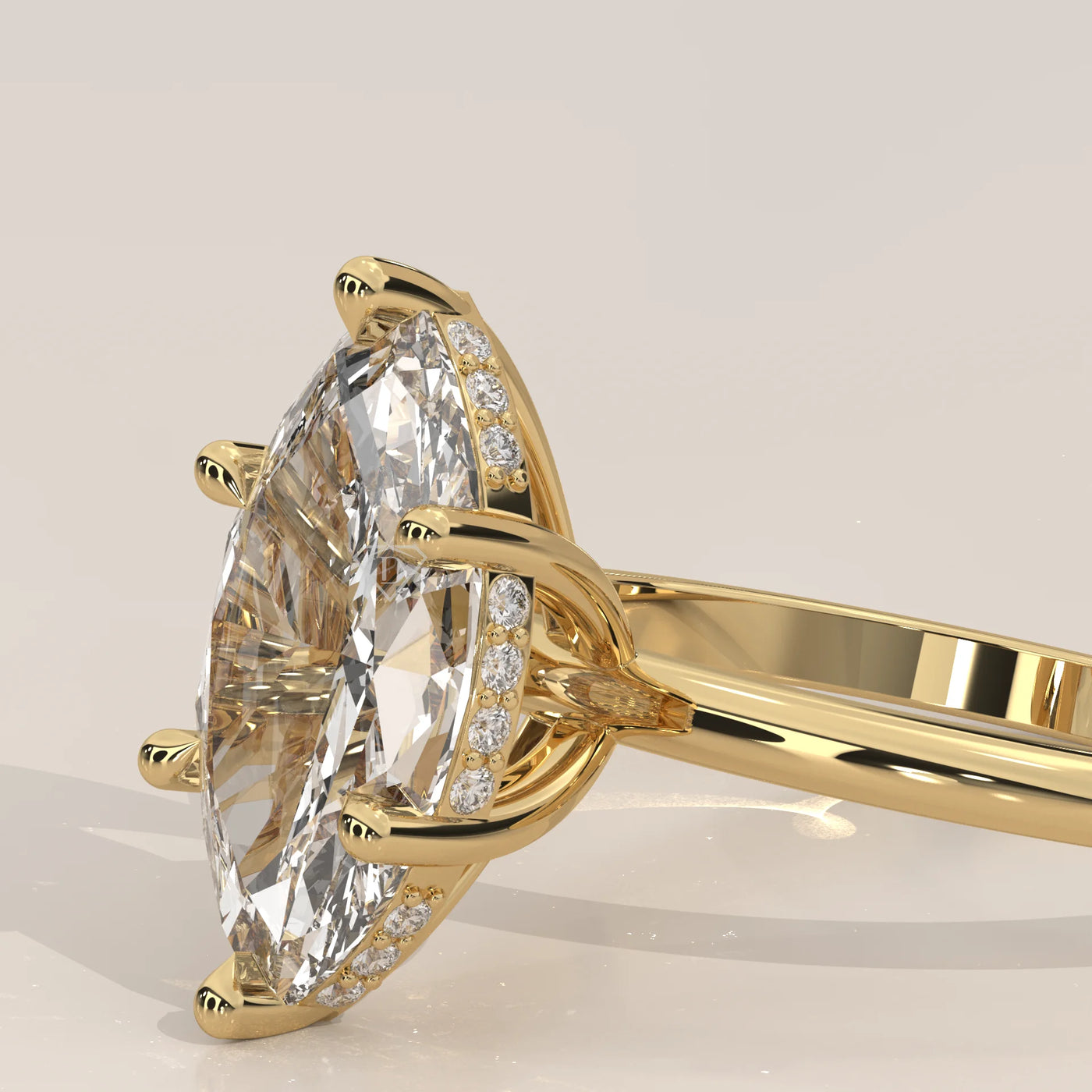 A close-up side view of a marquise-cut diamond ring in yellow gold.