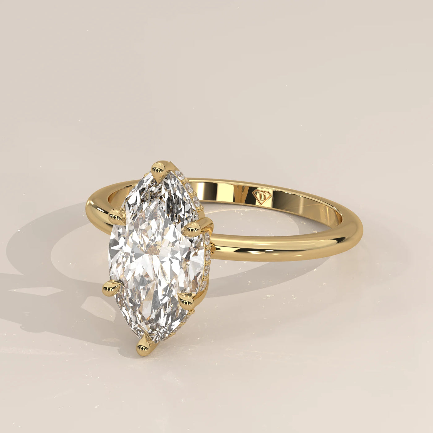A 14k yellow gold ring with a large marquise-cut diamond and a simple band.