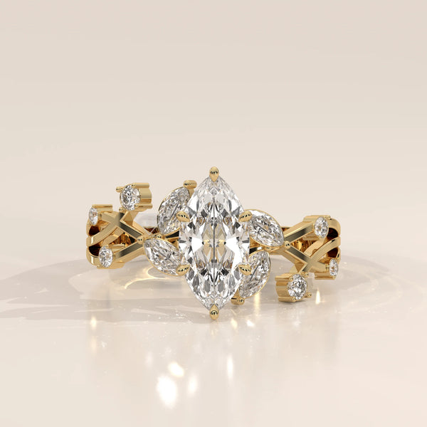 Elegant yellow gold ring featuring a marquise-cut diamond and accent stones.