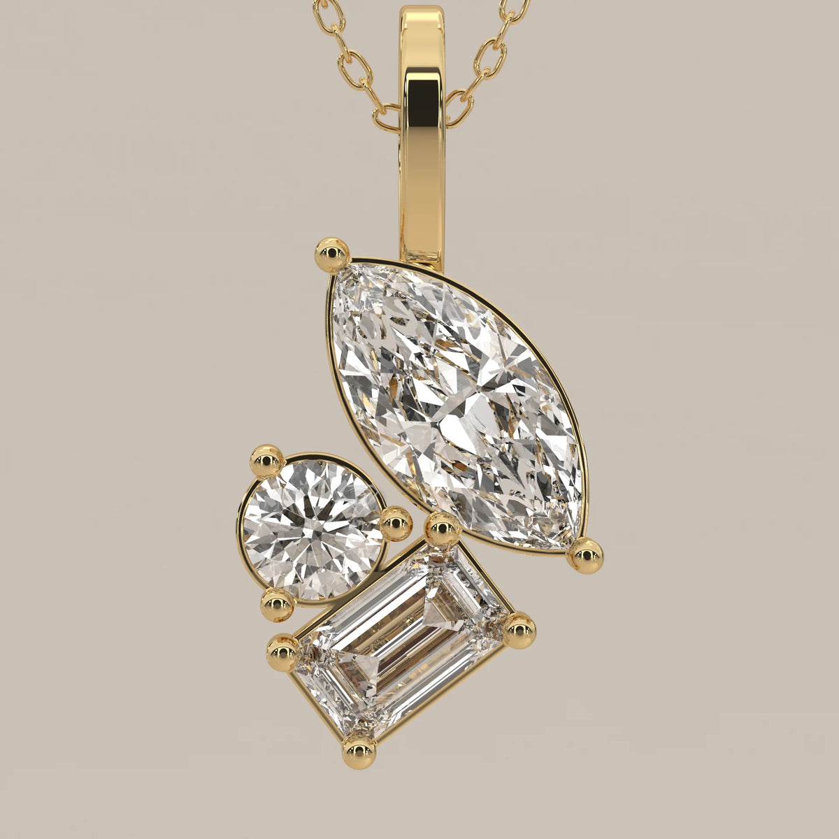 Marquise, Emerald and Round Lab Grown Diamond Cluster Pendant in yellow gold, photographed head-on.