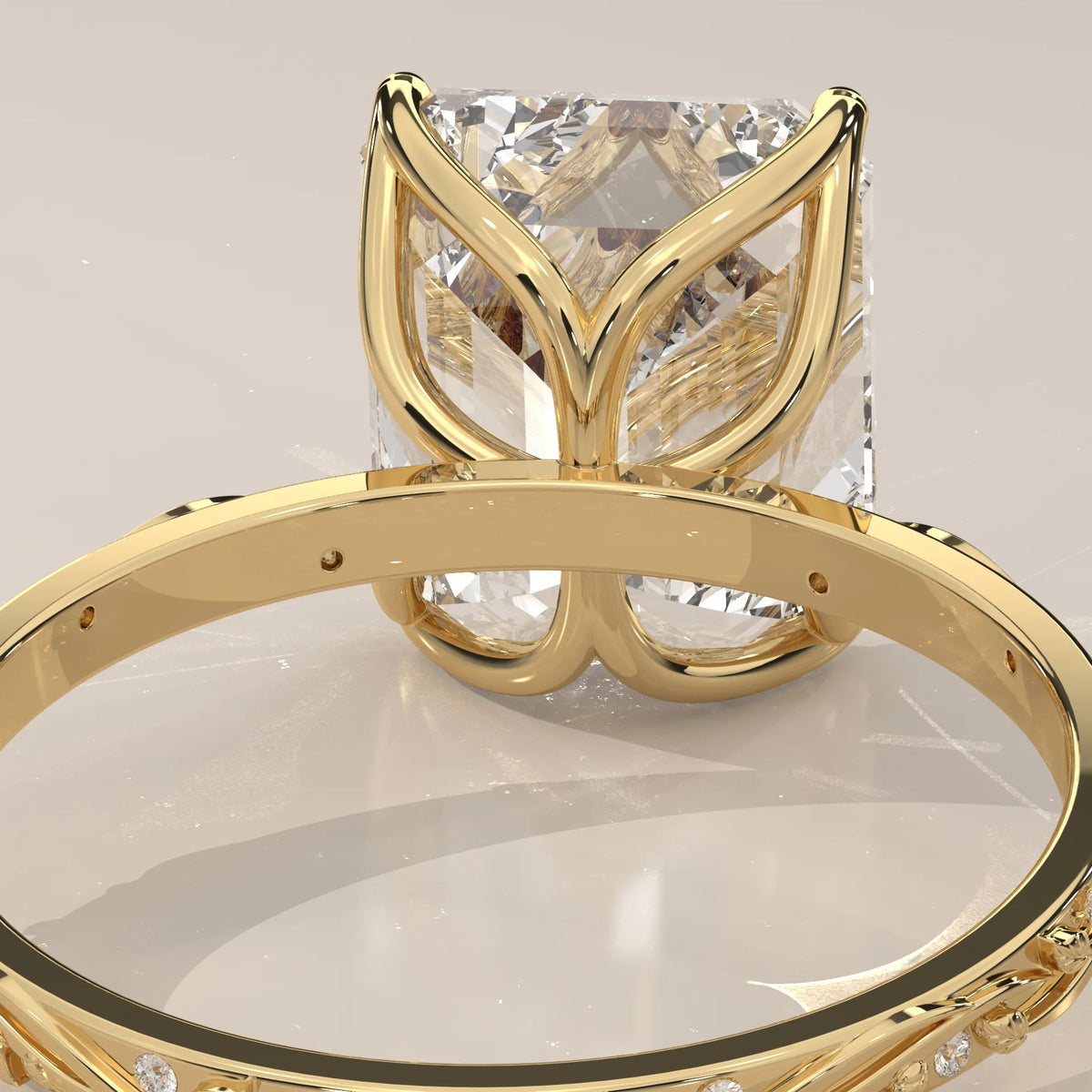 Miloise 5 Carat Emerald Cut Lab Grown Diamond Ring, Engraved Vine in yellow gold, close-up of the tulip basket under the emerald cut.