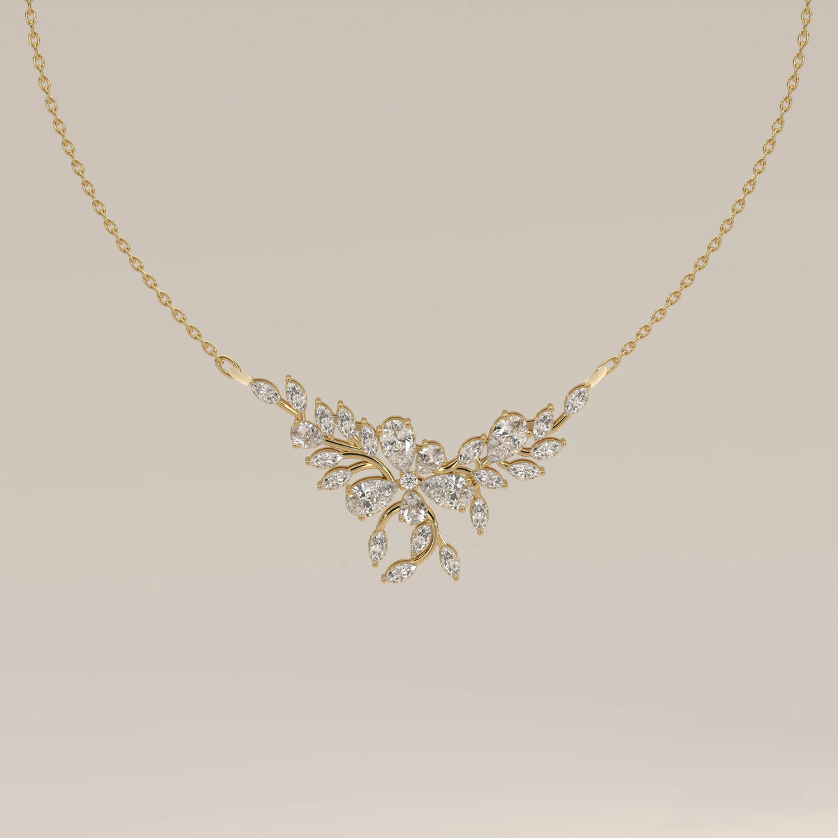A marquise and pear lab grown diamond leaf necklace in yellow gold, shown from the front.