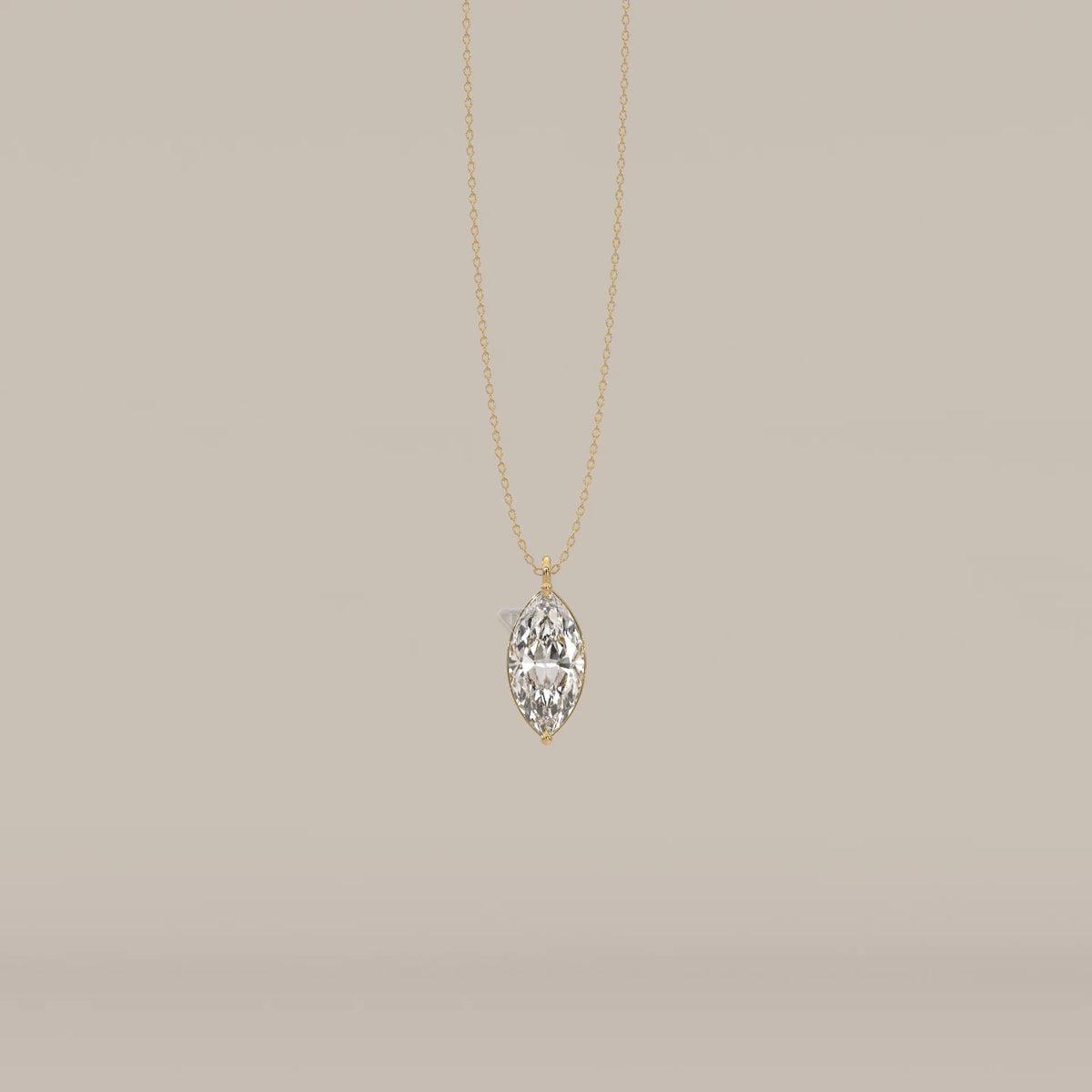 A delicate gold chain necklace with a large marquise-cut diamond pendant.