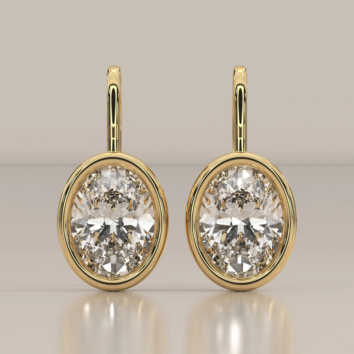 Oval Bezel Set Lab Grown Diamond Drop Earrings on a Gold Hook in yellow gold, shown from the front.
