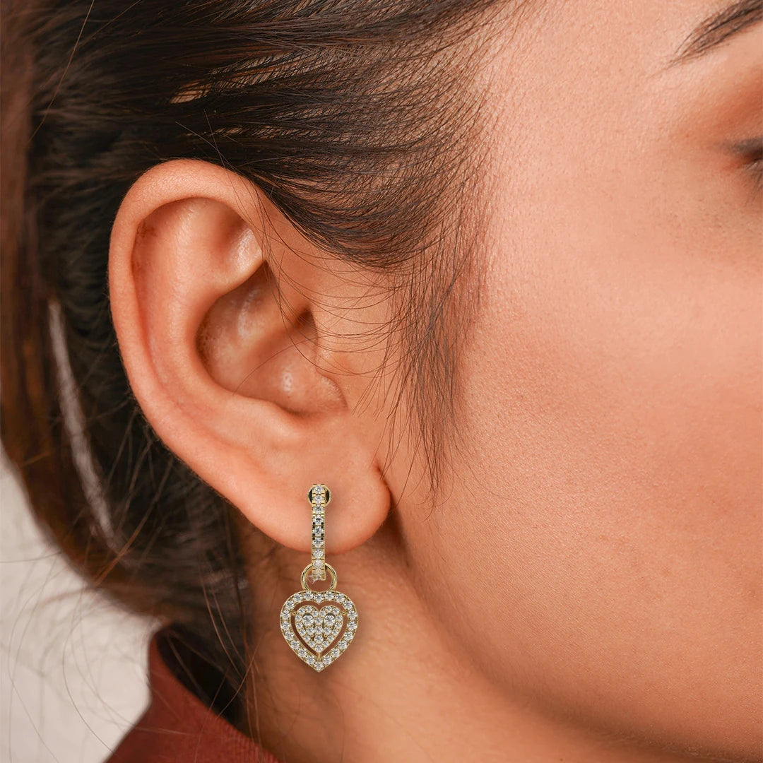 Pave Heart Lab Grown Diamond Drop Earrings on a Half Hoop Post in yellow gold, worn on the model.