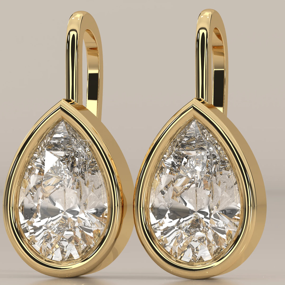 Pear Bezel Lab Grown Diamond Drop Earrings on a Solid Gold Hook in yellow gold, photographed head-on.