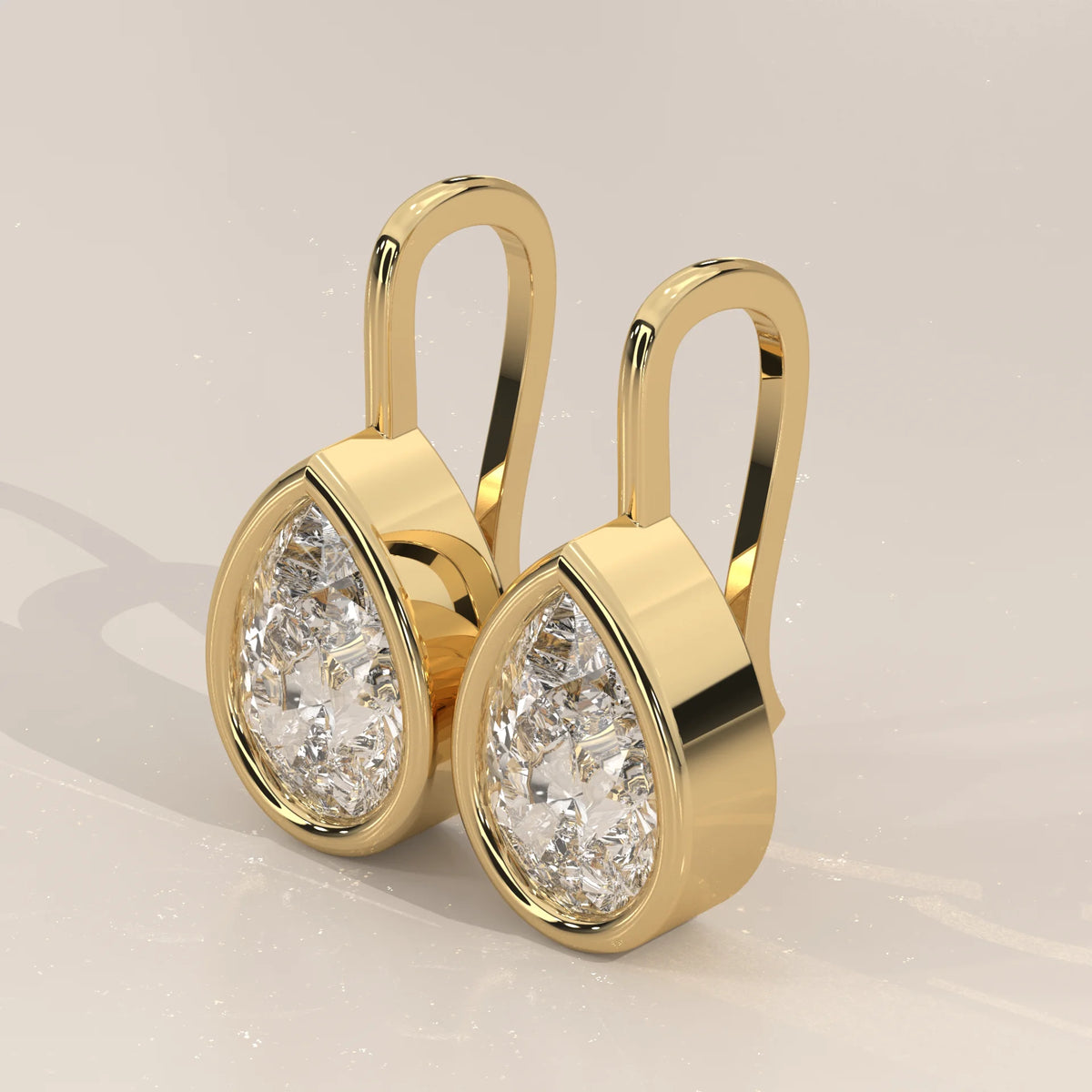 Pear Bezel Lab Grown Diamond Drop Earrings on a Solid Gold Hook in yellow gold, shown from the side.