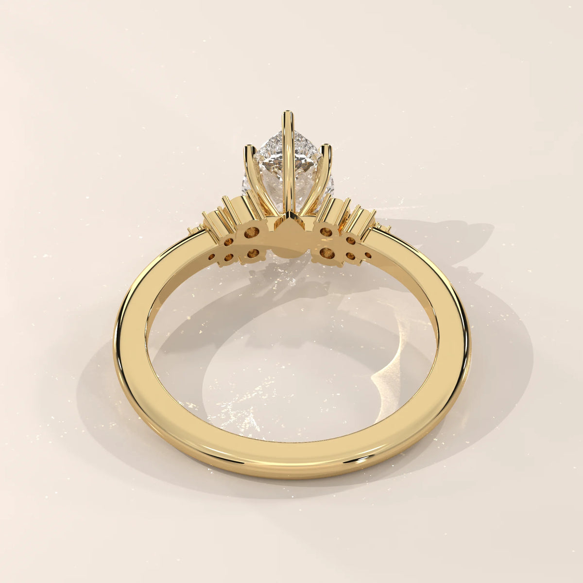 Elegant 14k yellow gold ring with a pear-cut diamond and accent stones.
