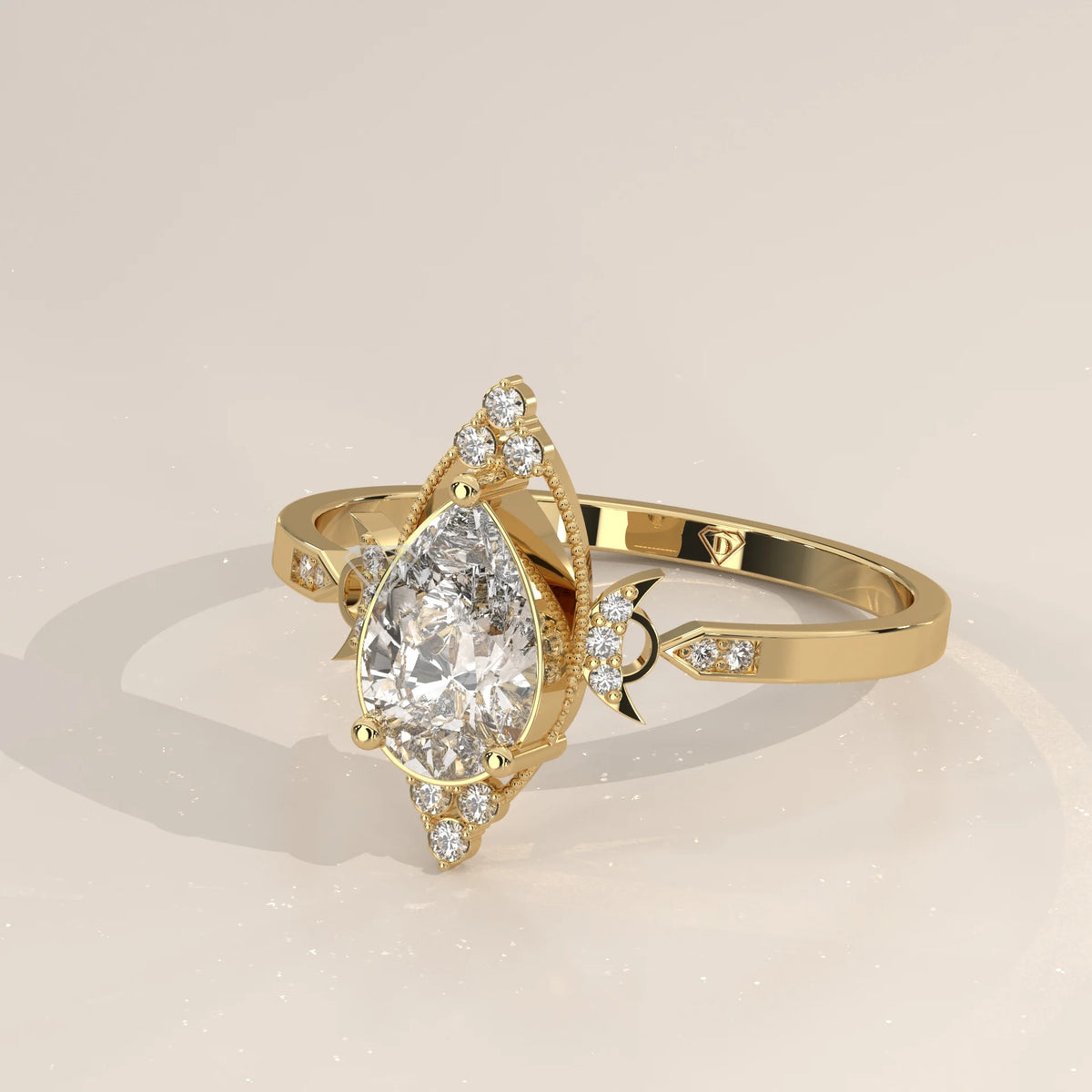 A stunning 14k yellow gold ring with a pear-cut diamond and accent stones.