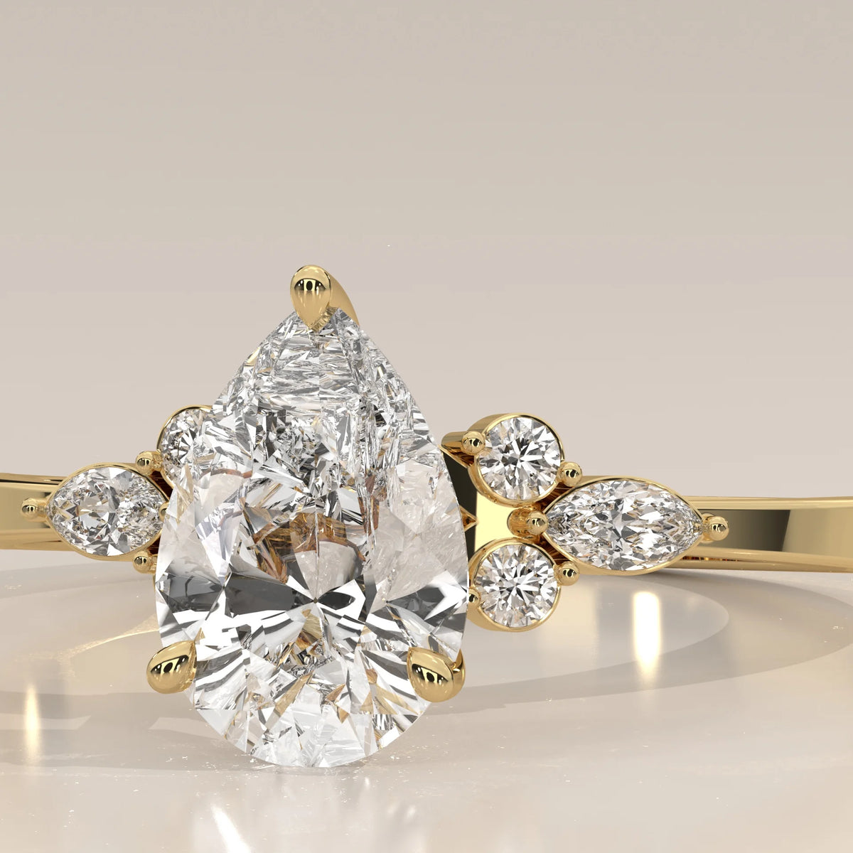 Elegant 14k gold ring with a pear-shaped diamond and intricate band design.