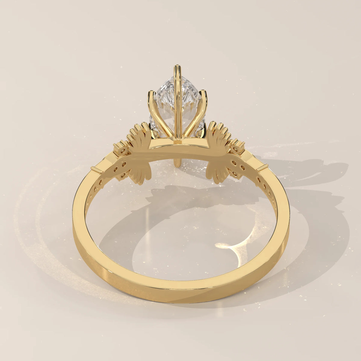 Gold ring with a pear-shaped diamond and two round diamonds.