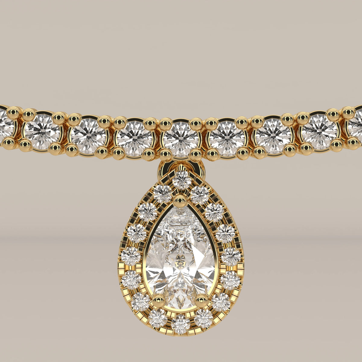 A pear halo lab grown diamond teardrop tennis necklace in yellow gold, shown on a plain background.