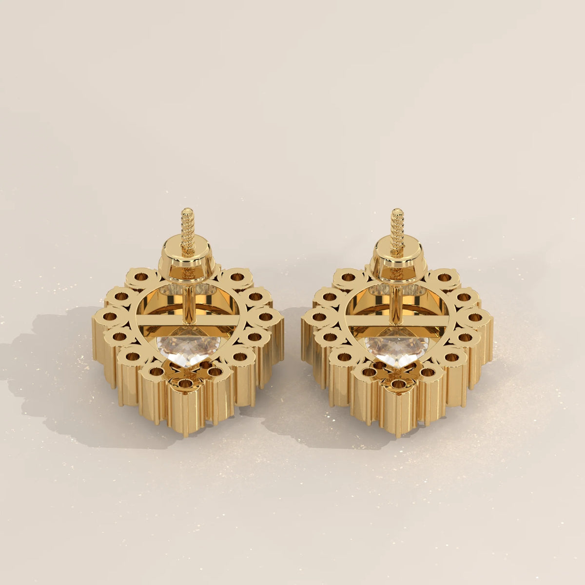Pear Lab Grown Diamond Studs in a Raised Cup Halo with Milgrain in yellow gold, studio photograph on a plain background.