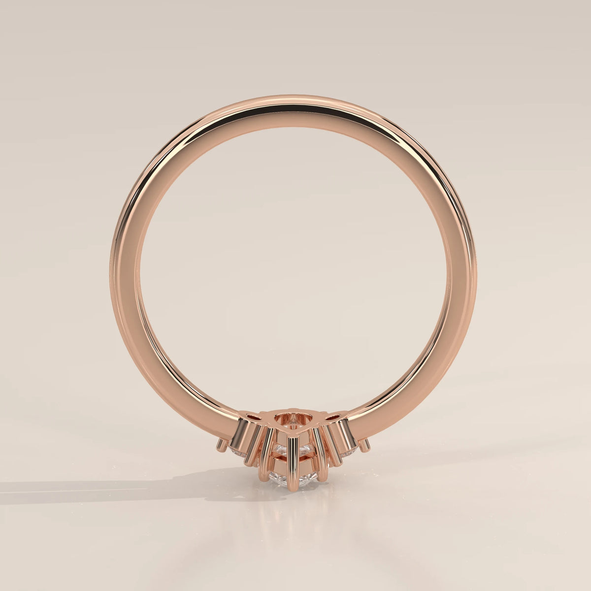 Profile view of pear three stone ring showing rose gold setting height