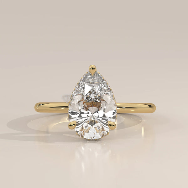 A classic 14k gold ring featuring a pear-shaped diamond.